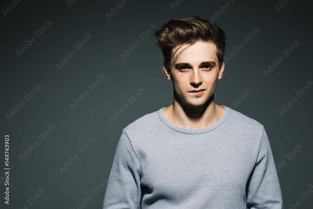 Handsome in style. Cheerful young man in smart casual wear while standing against grey background Handsome in style. Cheerful young man in smart casual wear while standing against grey background