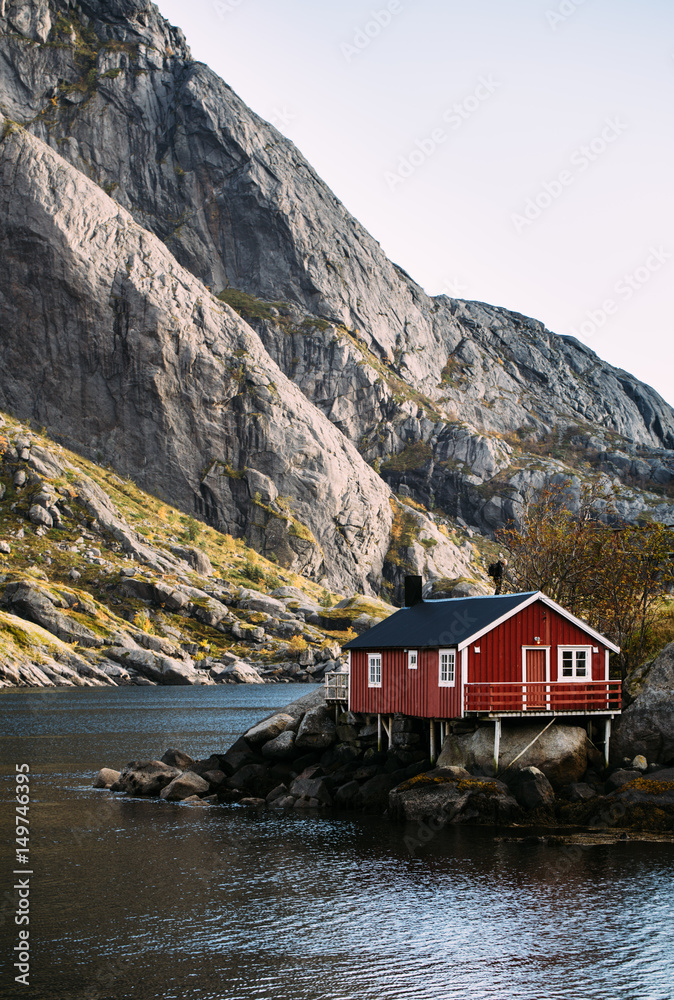 Lofoten islands is an archipelago in the county of Nordland, Norway. Distinctive scenery with dramatic mountains and peaks, open sea and sheltered bays and red fishing huts, called rorbu.