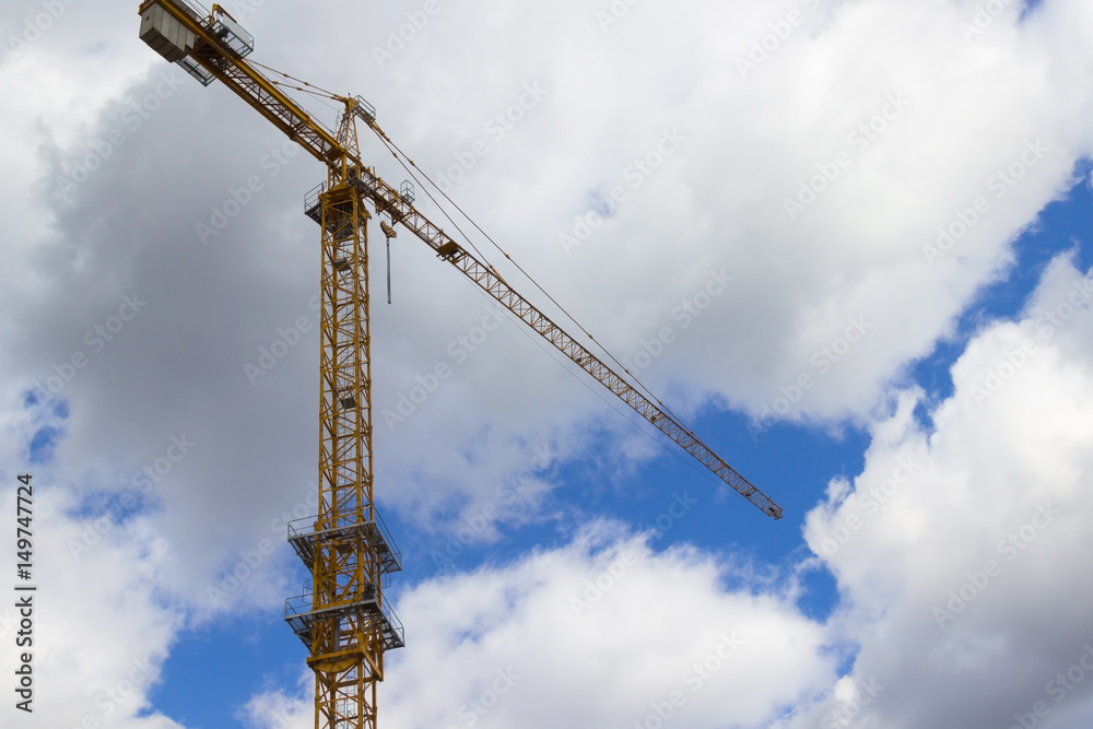 Construction cranes and buildings on background cloudy sky. Construction cranes and buildings on background cloudy sky.