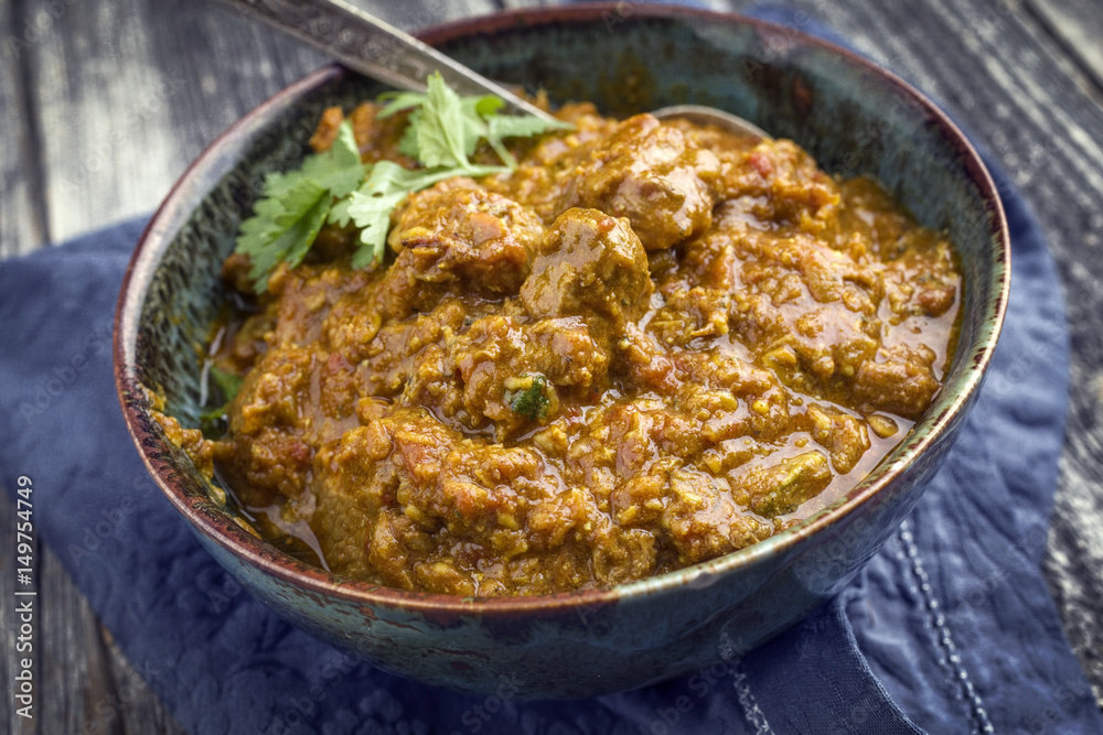Traditional Indian Lamb Curry as close-up in a Korai