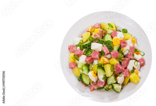 Fresh salad with potato, egg, salami, cucumber and green onion. top view. isolated on white