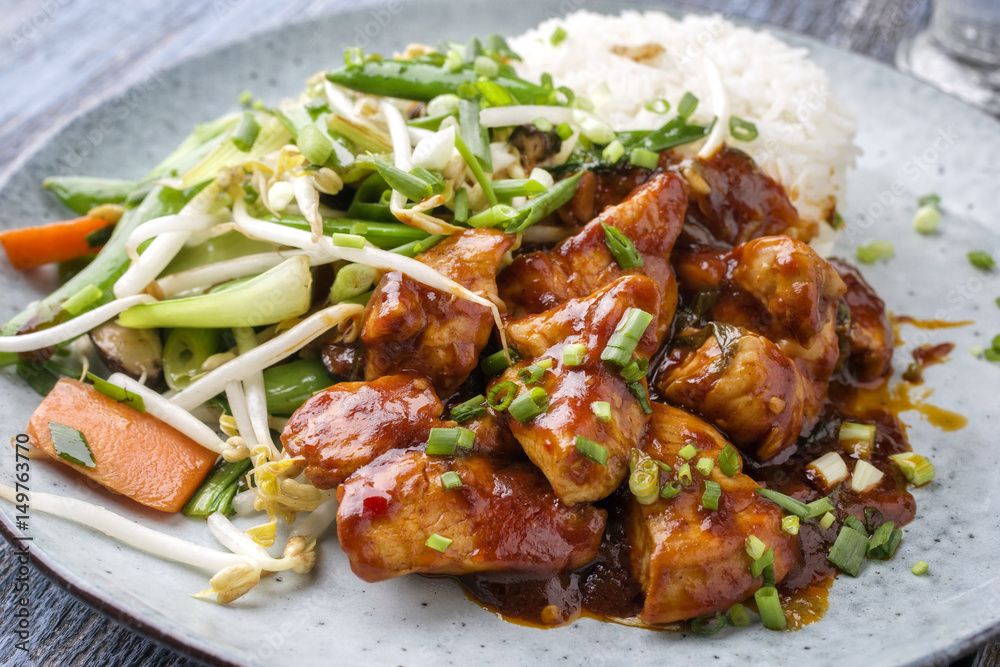 Chicken sweet-sour with Vegetable and white Rice as close-up on a plate Chicken sweet-sour with Vegetable and white Rice as close-up on a plate