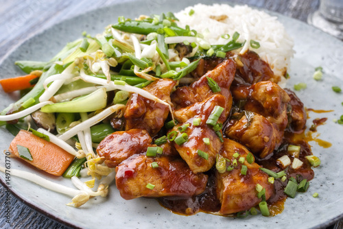 Chicken sweet-sour with Vegetable and white Rice as close-up on a plate