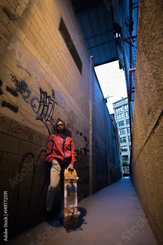 A candid portrait of a young, black woman, backlit by New York City streetlights. Shot during a Spring 2017 night in DUMBO, Brooklyn
