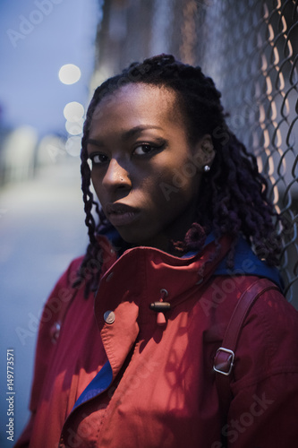 A portrait of a young, black woman with braids in Brooklyn, New York City. Shot in the streets using ambient light during the Spring of 2017.