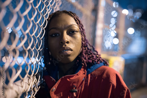 A portrait of a trendy, urban, black woman. Shot using streetlights during the Spring of 2017. photo