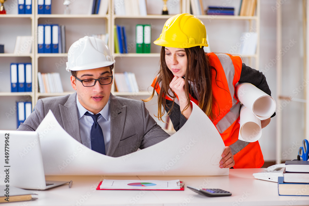 Construction foreman supervisor reviewing drawings Construction foreman supervisor reviewing drawings