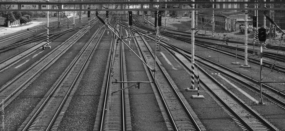 Monochrome outdoor photo of railway tracks on station