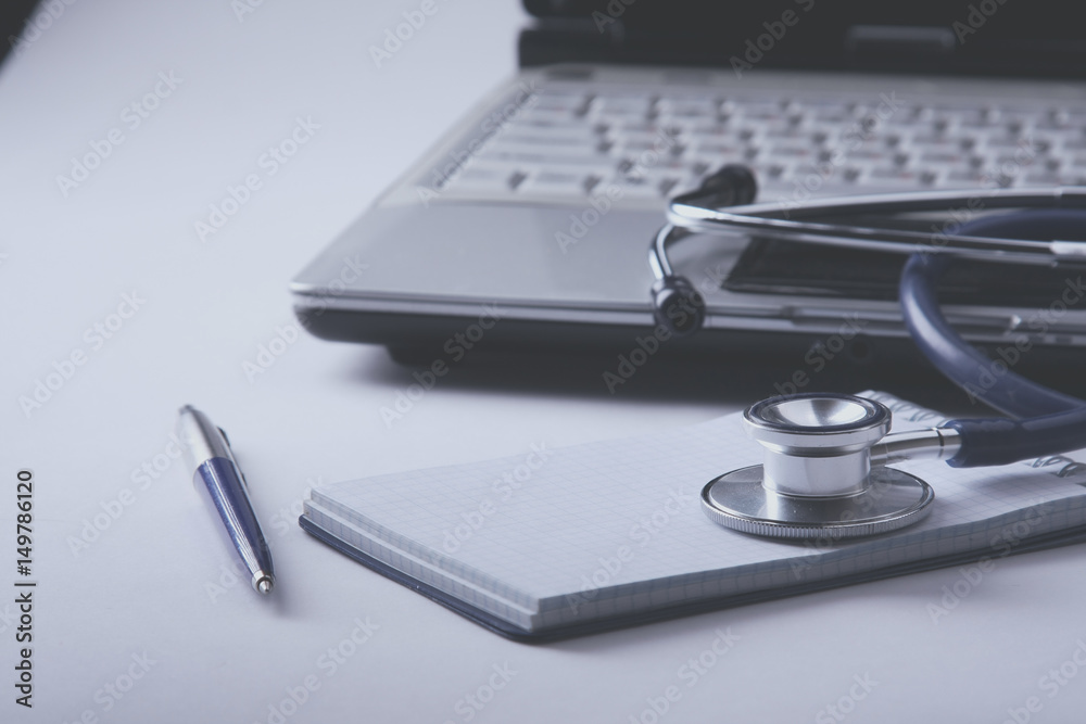 Medical stethoscope , laptop, folder on the desk Medical stethoscope , laptop, folder on the desk