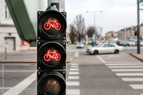 Red bicycle traffic lights on the city street background