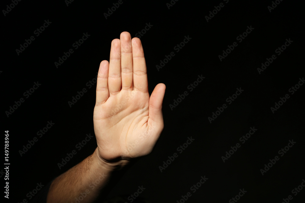 Male hand on a black background