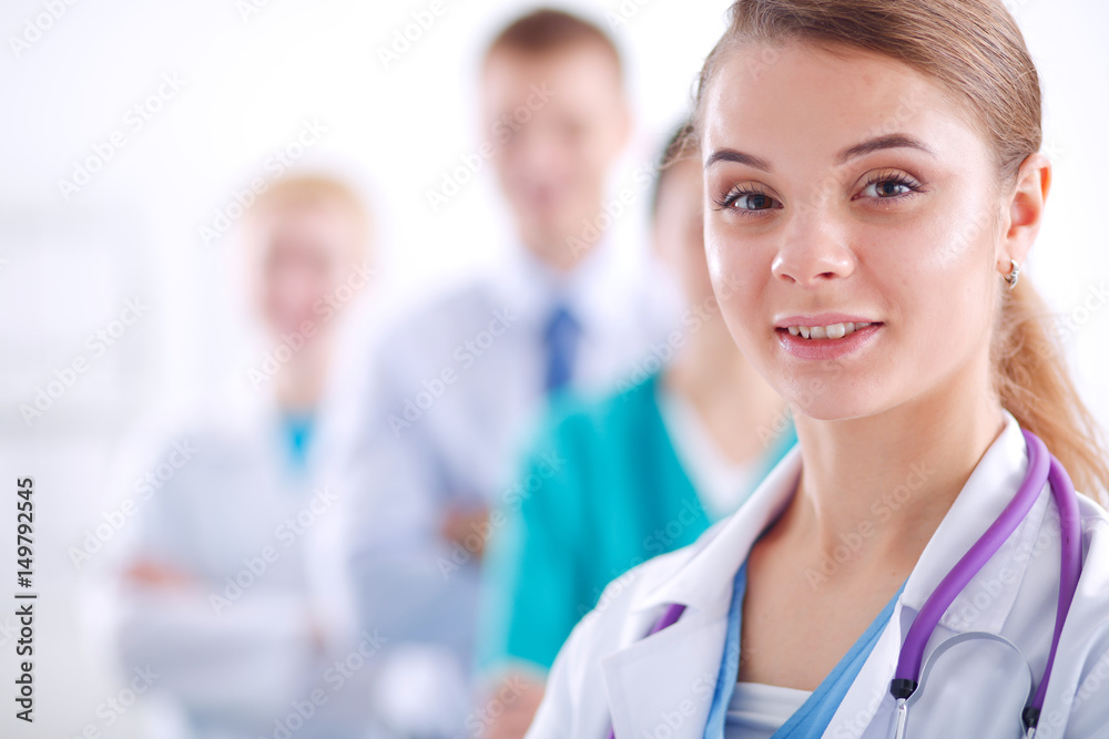 Attractive female doctor in front of medical group Attractive female doctor in front of medical group