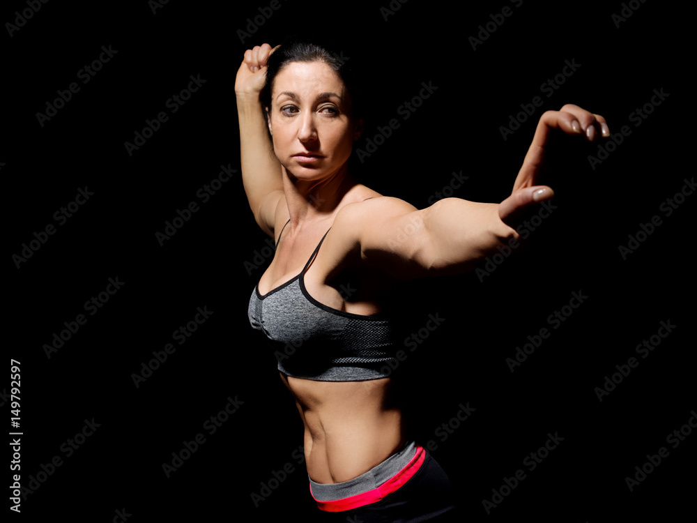 Muscular bodybuilder woman showing her muscles. Muscular bodybuilder woman showing her muscles.