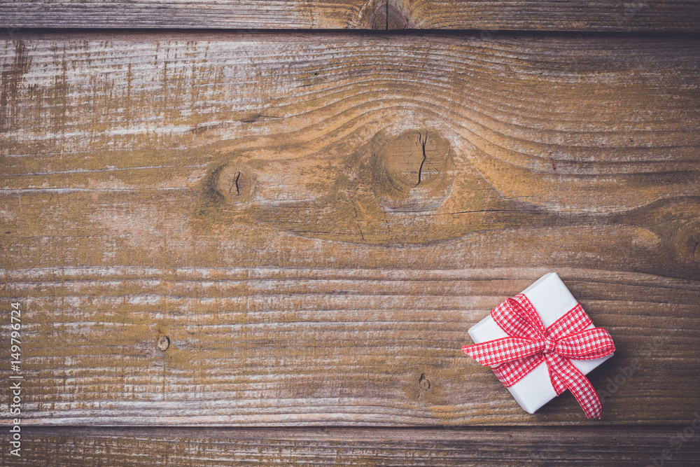 Small gift box on an old wooden background Small gift box on an old wooden background