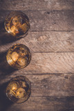 Whiskey glasses on an old wooden table. Top view