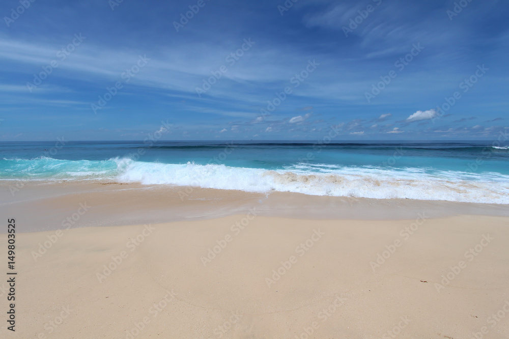 Bali beach with whate sand and blue waves in Bukit