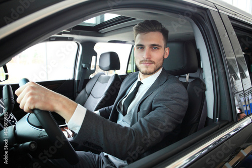 Portrait of an handsome guy driving his car. © opolja