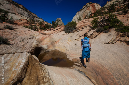 A woman with her baby boy are trekking in Zion national park, Utah, USA
