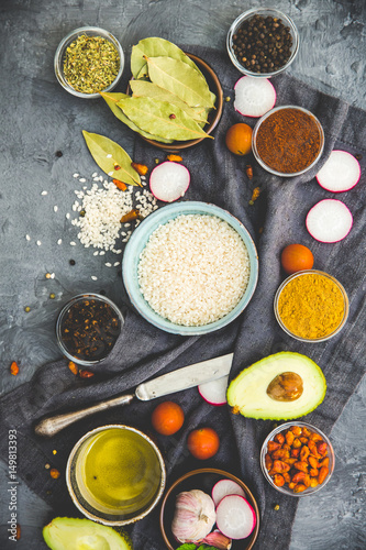 Rice and spices on dark rustic background