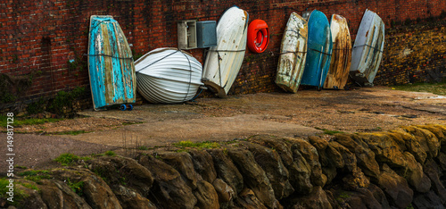 Boats  in a harbor, in the background stone promenade, seaside, stones and bricks