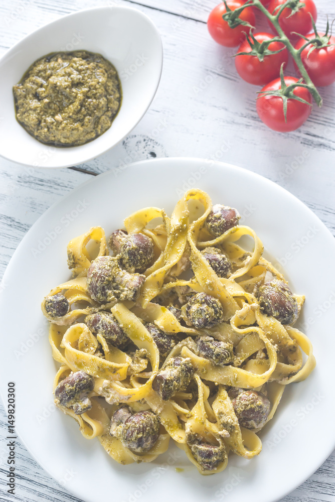 Portion of creamy mushroom pasta with pesto Portion of creamy mushroom pasta with pesto