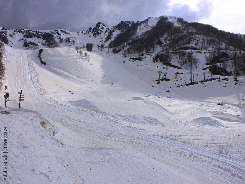 Snowy empty mountain ski gentle slope. Rosa Khutor, Sochi, Russia. Snowy empty mountain ski gentle slope. Rosa Khutor, Sochi, Russia.