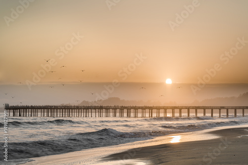 Fototapeta Naklejka Na Ścianę i Meble -  Hazy Sunset over Seacliff State Beach. Aptos, Santa Cruz County, California USA.