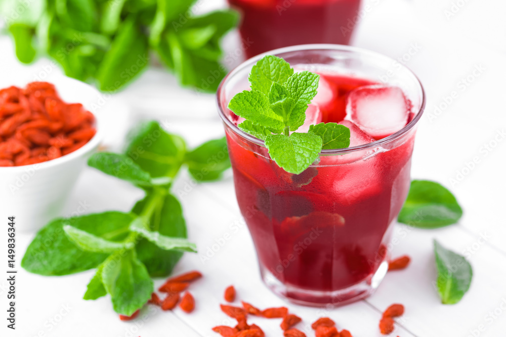 Healthy detox drink with goji berries infused in water with ice, cold refreshing beverage Healthy detox drink with goji berries infused in water with ice, cold refreshing beverage