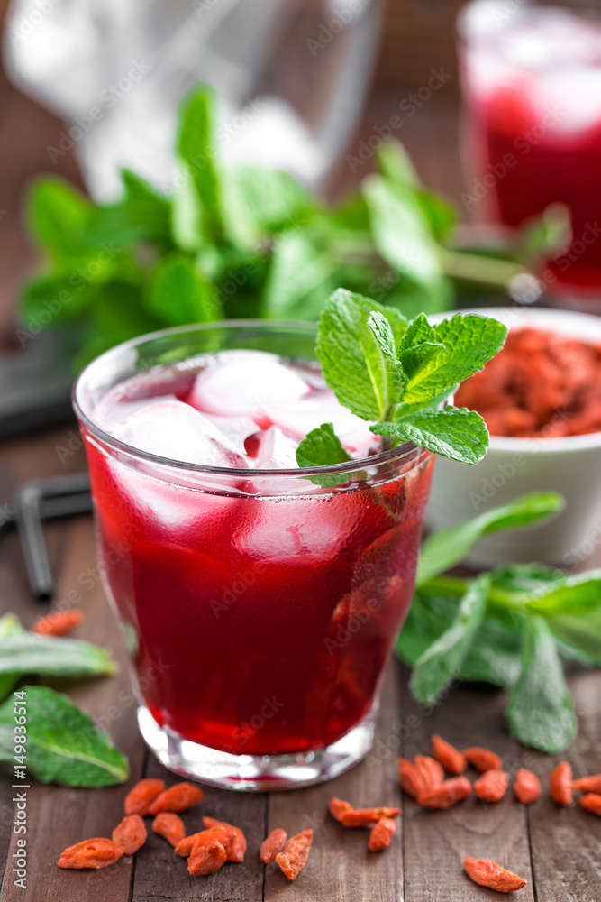 Healthy detox drink with goji berries infused in water with ice, cold refreshing beverage Healthy detox drink with goji berries infused in water with ice, cold refreshing beverage