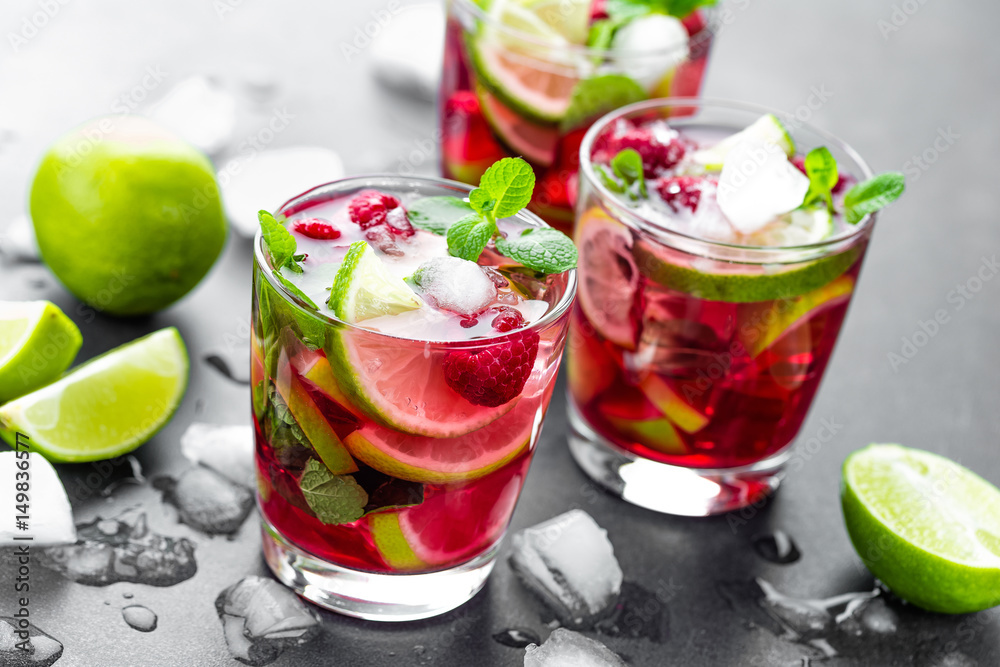 Raspberry mojito cocktail with lime, mint and ice, cold, iced refreshing drink or beverage Raspberry mojito cocktail with lime, mint and ice, cold, iced refreshing drink or beverage