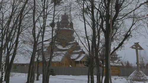 Ancient Wooden Monastry Skit of All Saints Orthodox Sviatogorskaya Lavra Building With Beautiful Old Domes Being Encircled With Log Fence Walk by Park photo