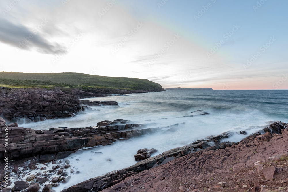 Waves crashing on the shores of Newfoundland in the setting sun Waves crashing on the shores of Newfoundland in the setting sun