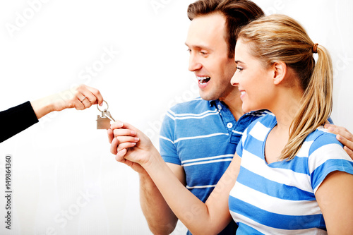 Real estate agent giving keys to the couple