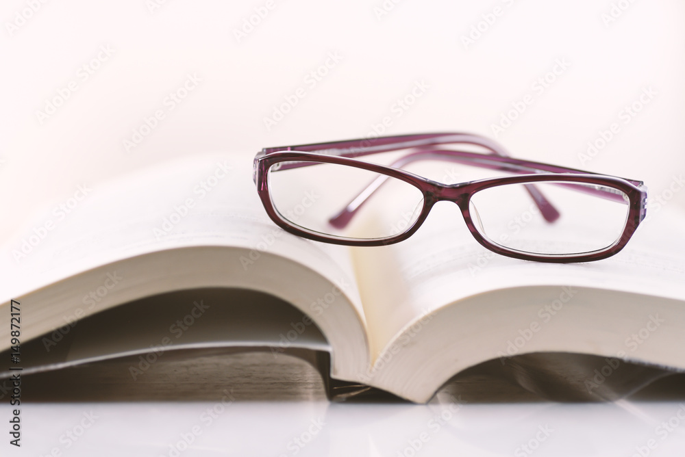 Education,Book and glasses on white background Education,Book and glasses on white background
