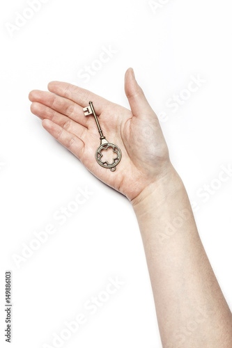 woman hand hold a vintage key isolated white.