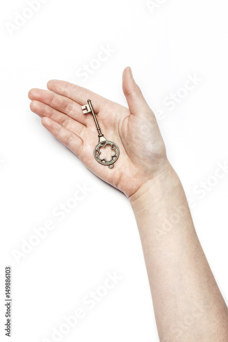 woman hand hold a vintage key isolated white. photo