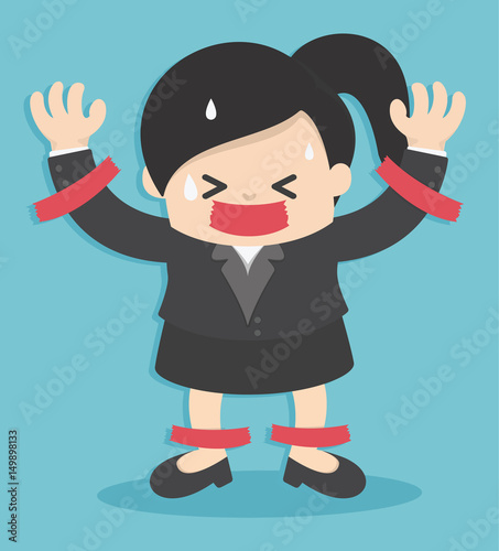 Business woman in suit is taped to the wall with adhesive tape