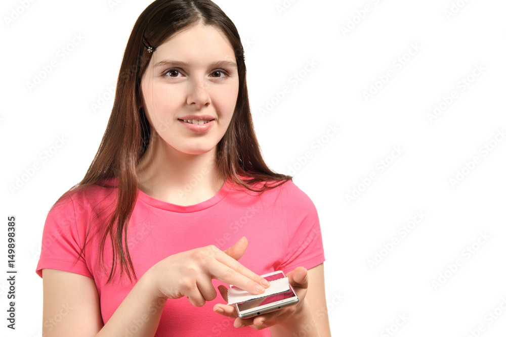young girl in pink dress polishes the screen of a smartphone young girl in pink dress polishes the screen of a smartphone