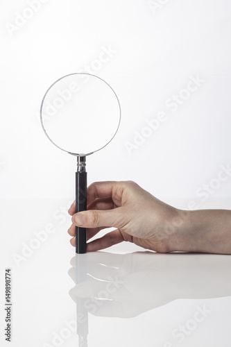 woman hand hold a sand timer isolated white.