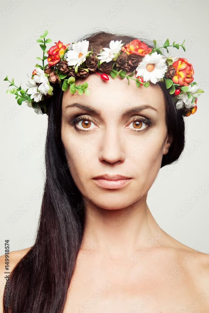 Pretty woman with spring flower wreath 