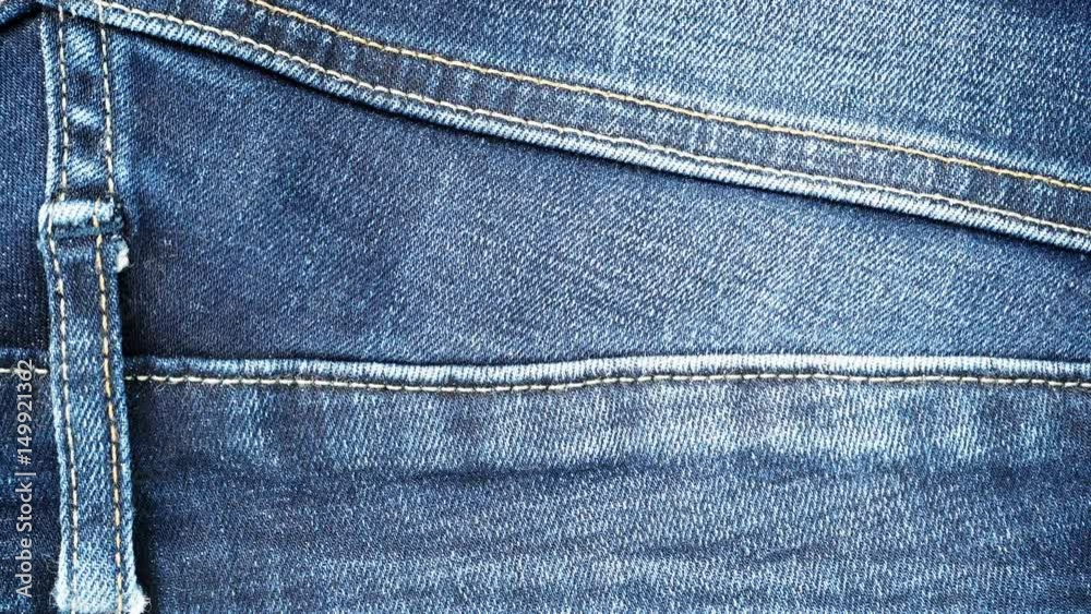 Closeup detail of blue denim jeans belt loop, texture background. Dolly slider shot 4K ProRes HQ codec Closeup detail of blue denim jeans belt loop, texture background. Dolly slider shot 4K ProRes HQ codec