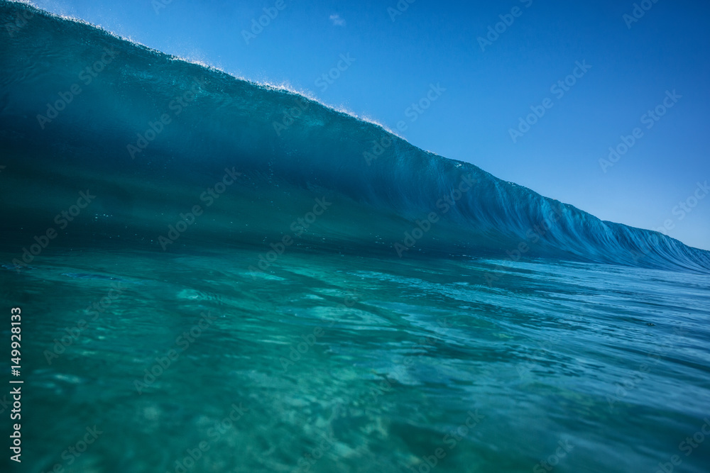 Big ocean wave in pipeline shape rising. Sea water ready to break