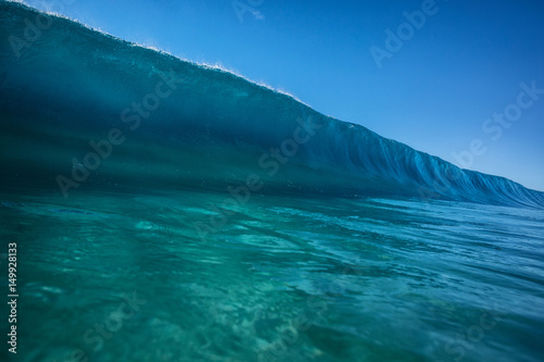 Fototapeta Naklejka Na Ścianę i Meble -  Big ocean wave in pipeline shape rising. Sea water ready to break