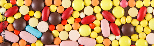 Colorful medical pills and capsules as background, health care concept © ratmaner