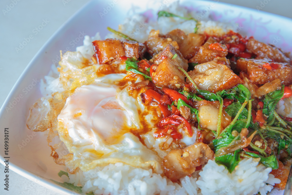 Spicy crispy pork puff with basil and fried egg. Spicy crispy pork puff with basil and fried egg.