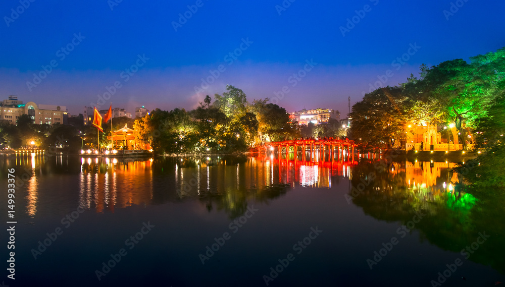 Tourists visit Hoan Kiem Lake Public park at night time in Hanoi city. Hoan Kiem Lake has mean 