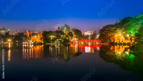 Tourists visit Hoan Kiem Lake Public park at night time in Hanoi city. Hoan Kiem Lake has mean " Lake of the Returned Sword" it one of Famous tourist destination in Vietnam.