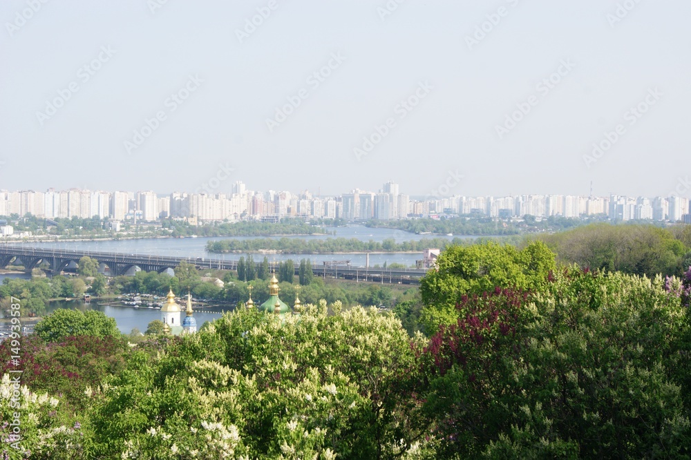 City above the big river, bridge over the river, spring, green trees