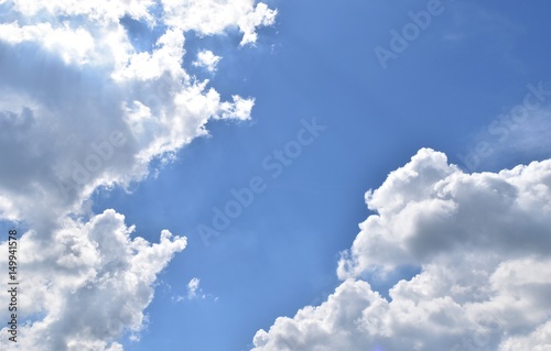Troll pointed nose talking with the man who has pointed beard and cheeks puffed.,Cloud shaped like a human on blue sky 