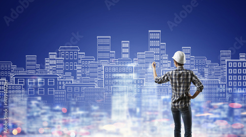 Builder woman sketching city